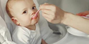 mother-feeding-her-little-baby-kitchen